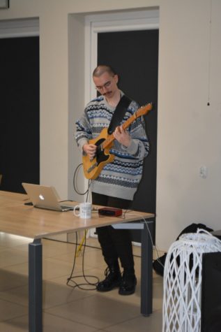 Na zdjęciu Pan Janek gra na gitarze elektrycznej.