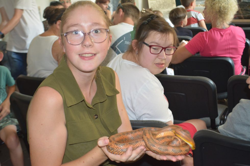 Na fotografii Wiktoria trzymająca na rękach węża.
